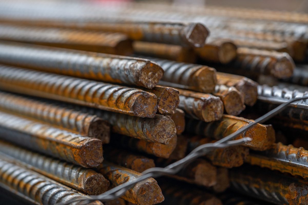 A stacked of rusty metal steel rods on the construction site